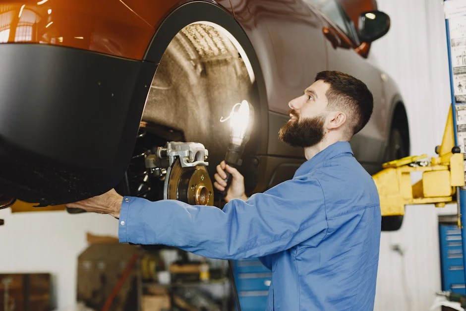 Professional mechanic inspecting the disc brake system of a vehicle in a modern auto repair shop.