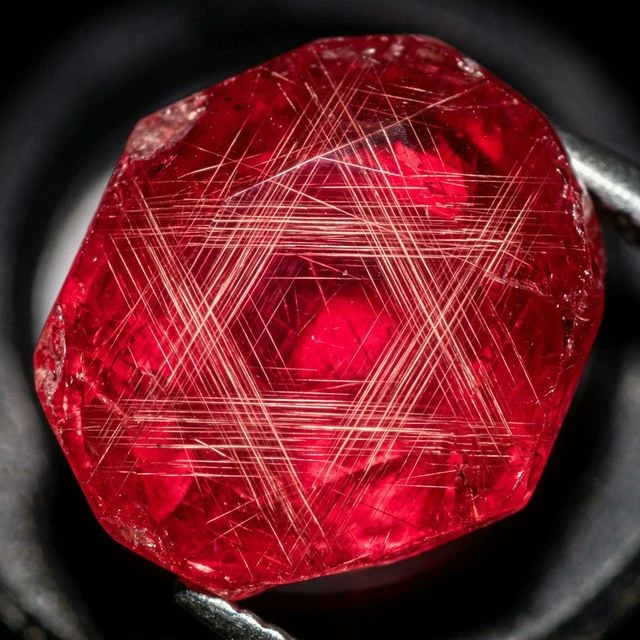 Microscopic view of silk inclusions in ruby, showing rutile needles at 60 and 120 degree angles.
