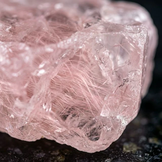 Macro photography showing microscopic fibrous inclusions inside rose quartz